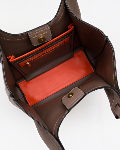 Interior view of the Montemaré Sedona tote bag in brown vegan leather with vibrant orange pockets and gold hardware.