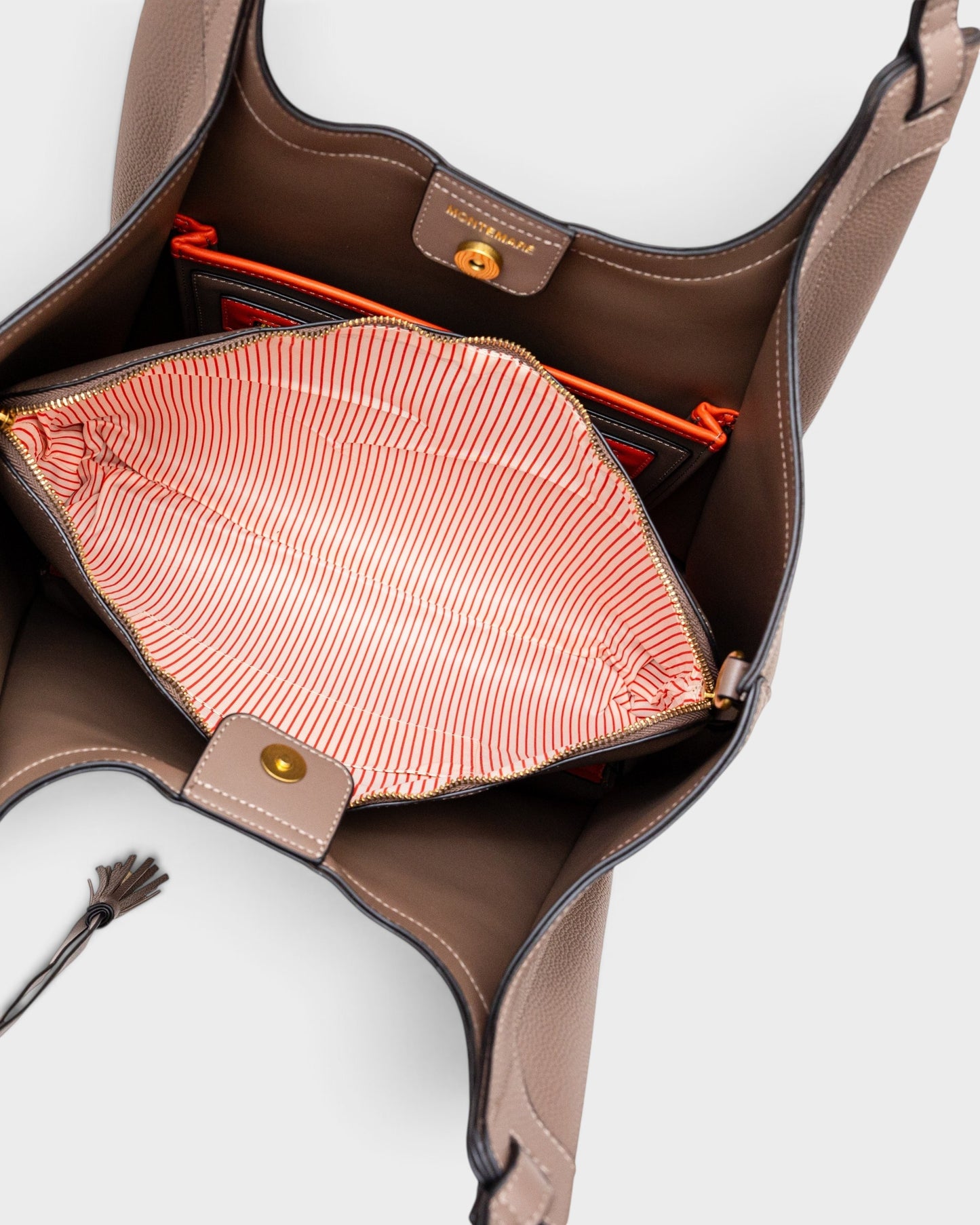 Montemaré Sedona Work Tote in taupe vegan leather with an open interior, orange accents, and a striped laptop sleeve.