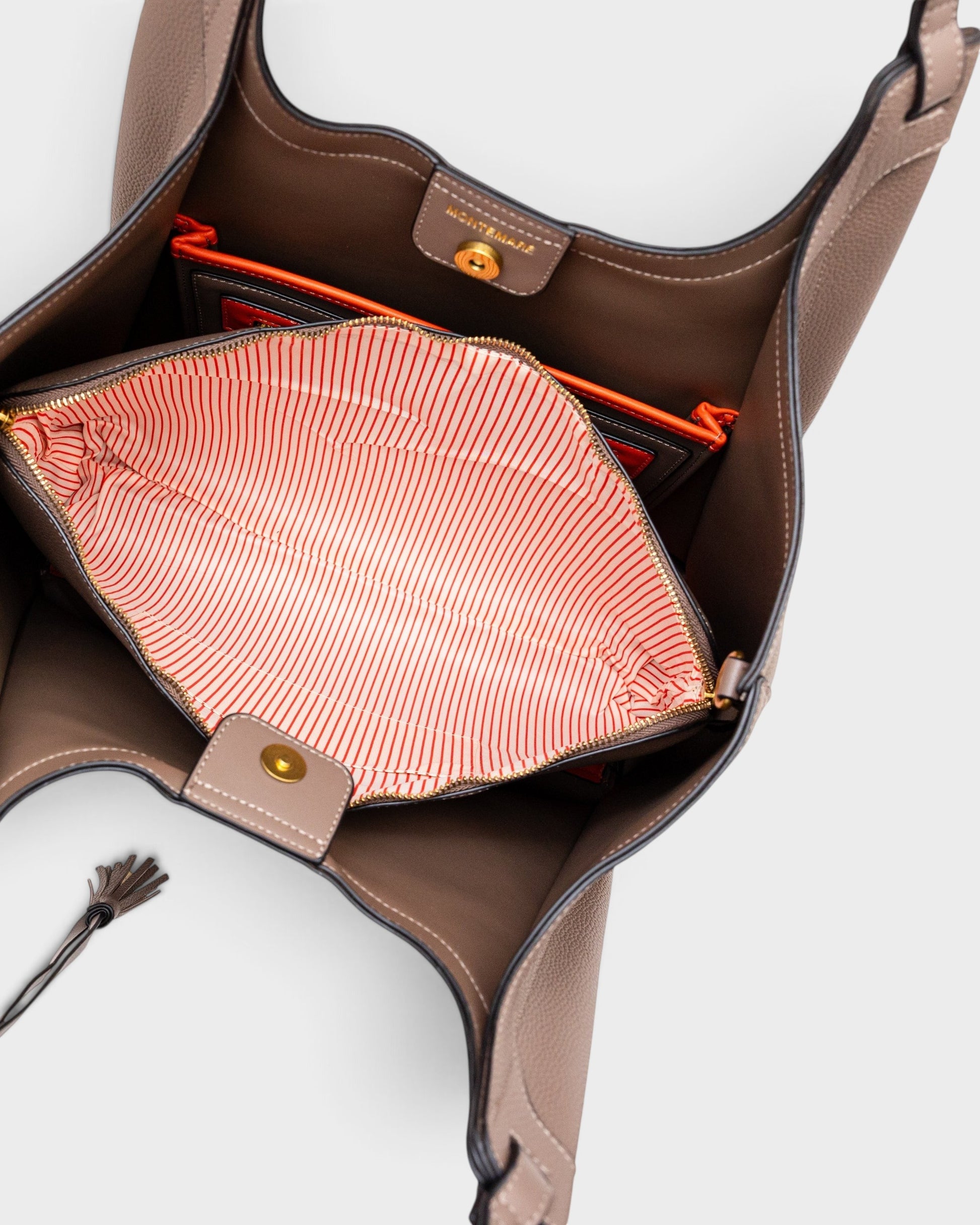 Montemaré Sedona Work Tote in taupe vegan leather with an open interior, orange accents, and a striped laptop sleeve.