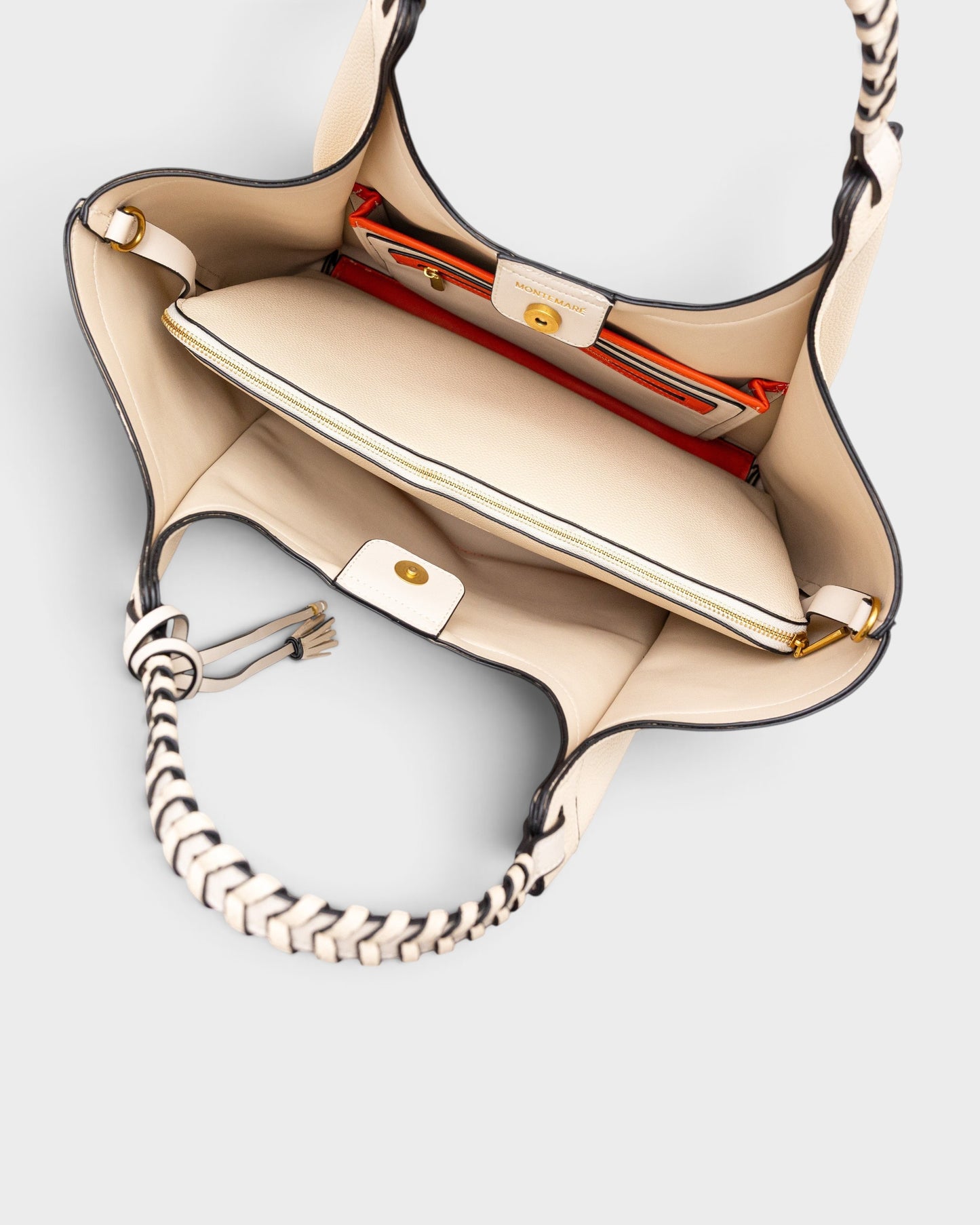 Interior view of Montemaré Sedona Work Tote in cream vegan leather with orange accents and removable laptop sleeve.