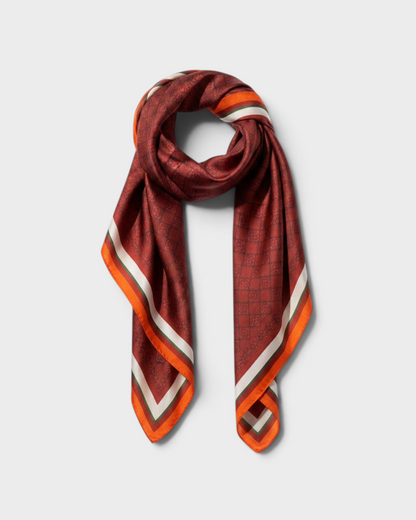 Montemaré Original Silk Square Scarf in a deep red grid pattern with orange, white, and green border accents.