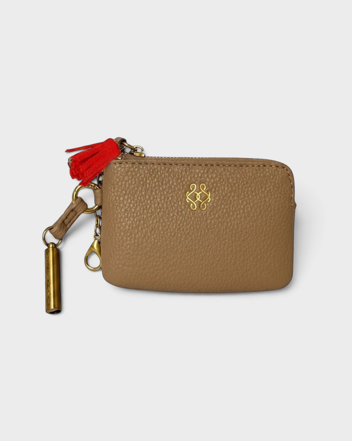 Montemaré tan vegan leather RFID card case with a red tassel, gold hardware, and a removable safety whistle keychain.