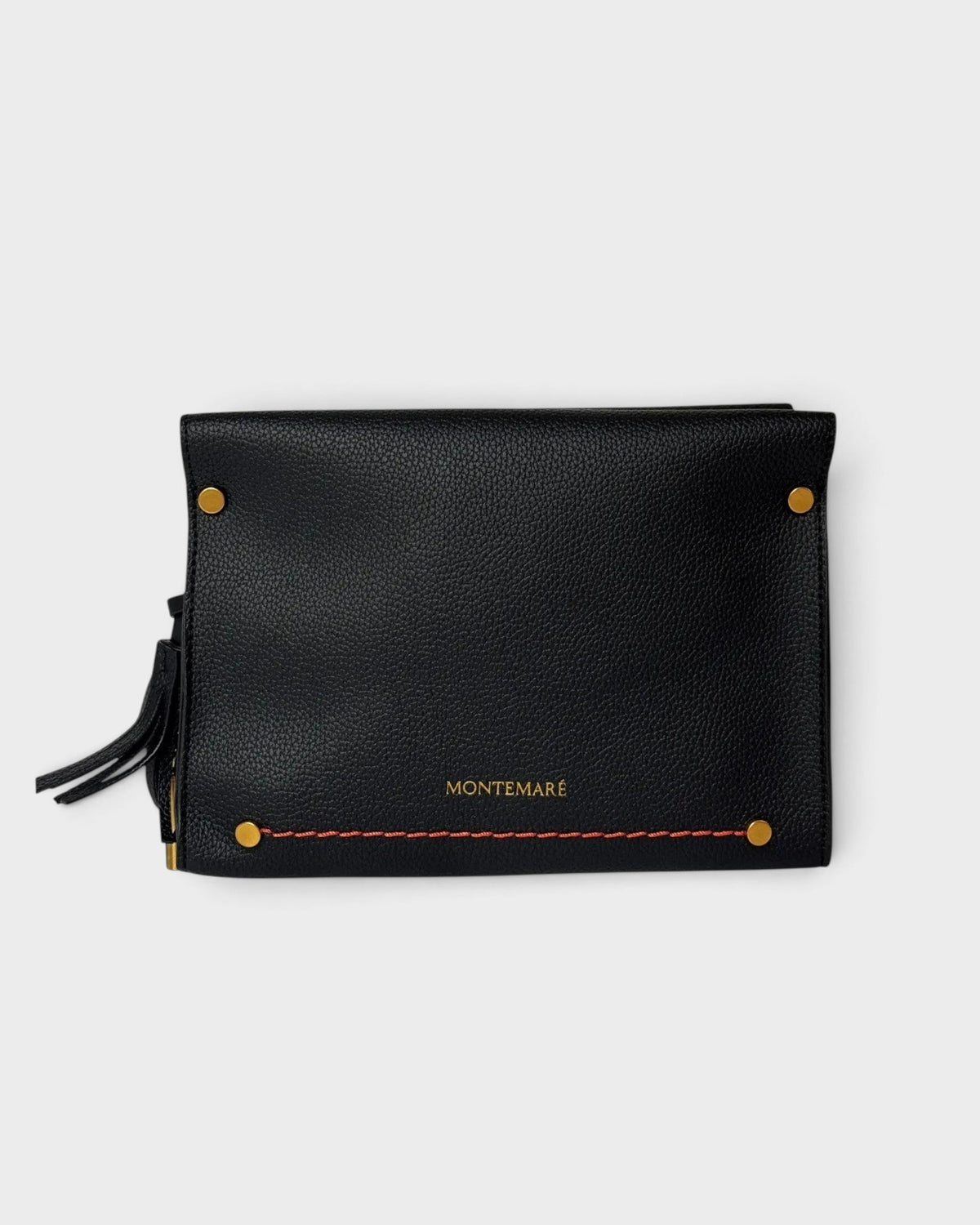 Montemaré Vienna black pebbled vegan leather crossbody bag with gold hardware and a safety whistle tassel.