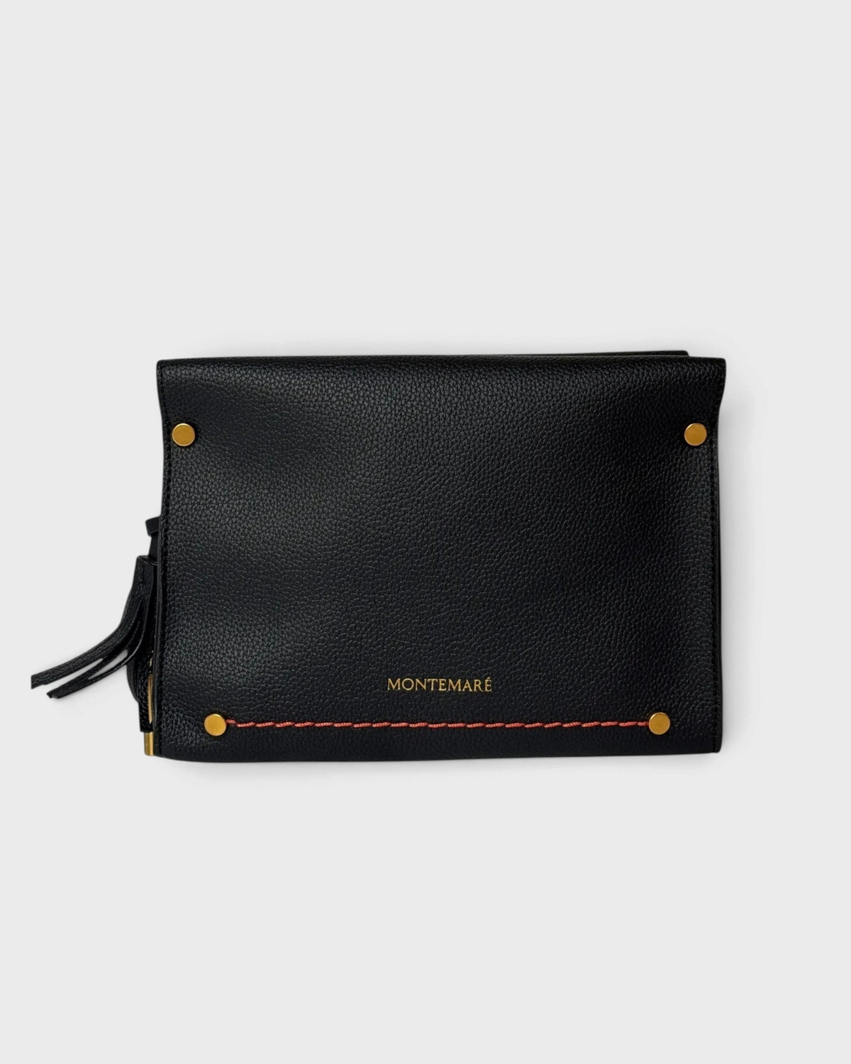 Montemaré Vienna black pebbled vegan leather crossbody bag with gold hardware and a safety whistle tassel.