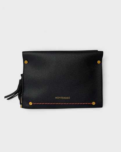 Montemaré Vienna black pebbled vegan leather crossbody bag with gold hardware and a safety whistle tassel.