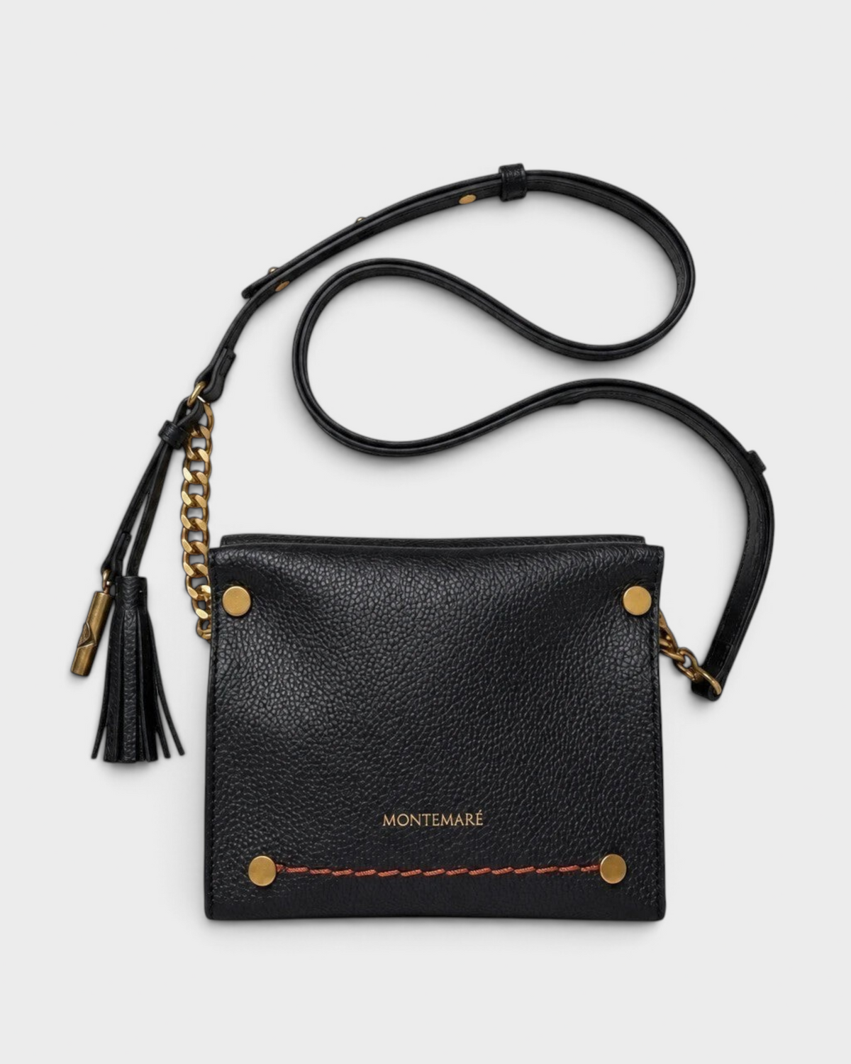 Montemaré Vienna Mini Crossbody in black pebbled vegan leather with gold chain detail and signature whistle tassel.