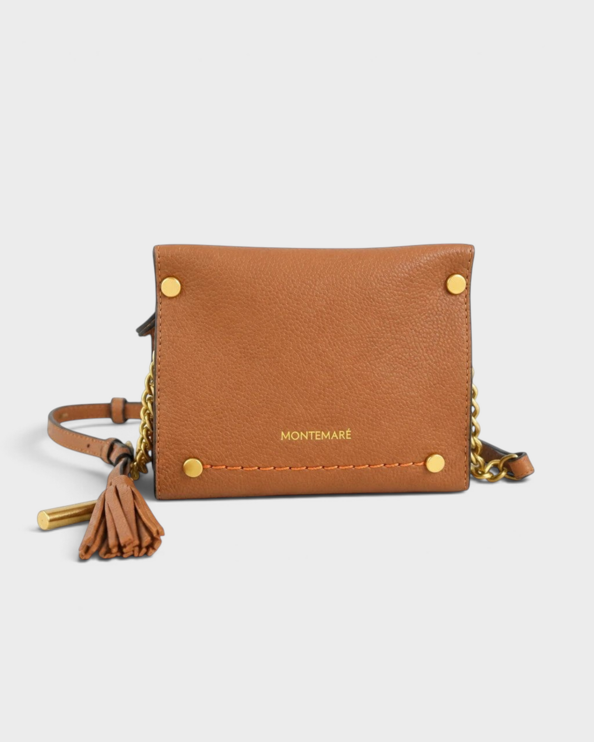 Montemaré Vienna Mini Crossbody in tan pebbled vegan leather with gold chain detail and signature whistle tassel.