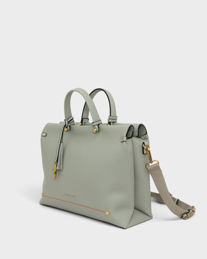 Montemaré Vienna small sage green vegan leather carry-on tote with gold hardware, tassel, and adjustable strap.