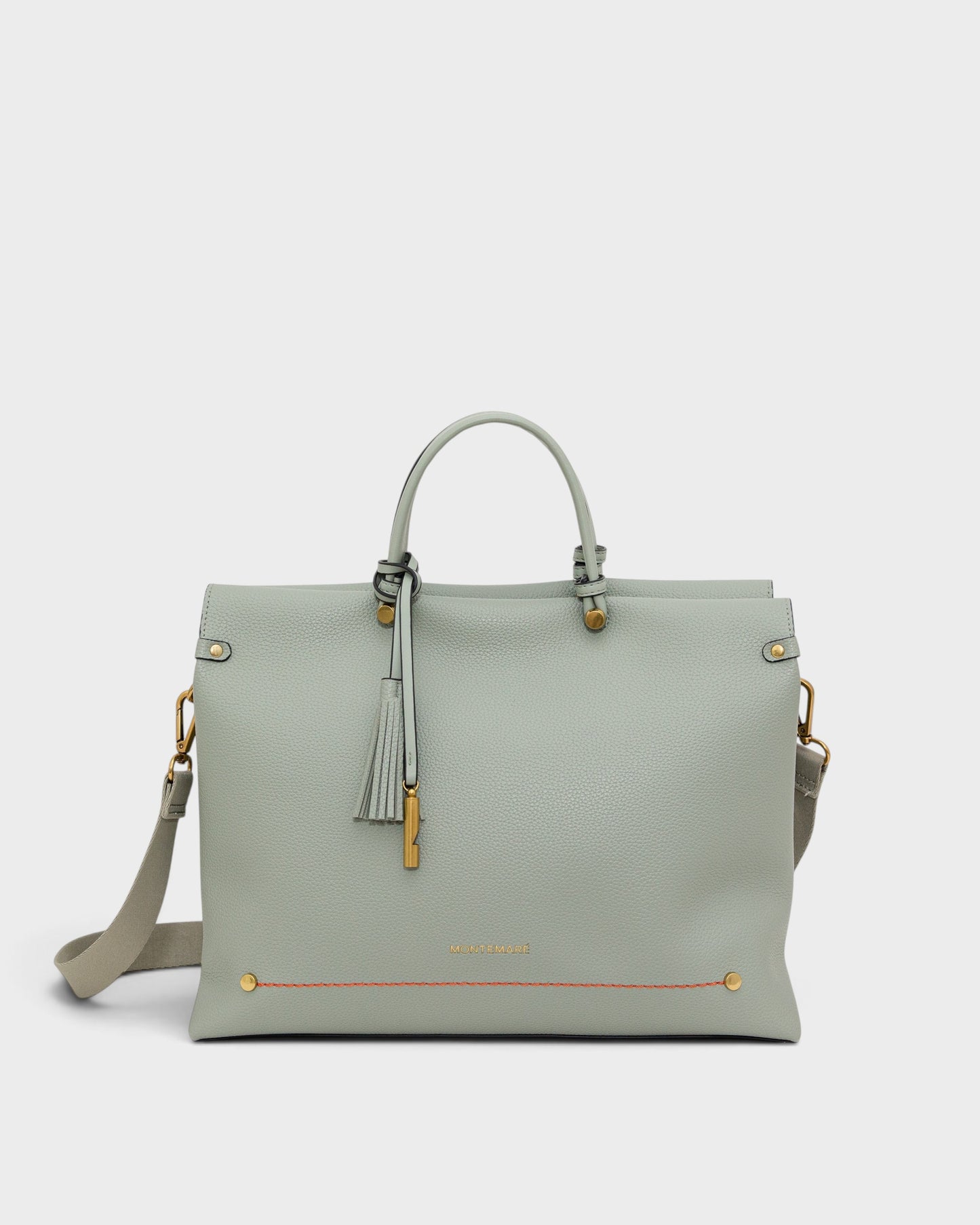 Montemaré Vienna small sage green vegan leather carry-on tote with a safety whistle tassel and adjustable strap.